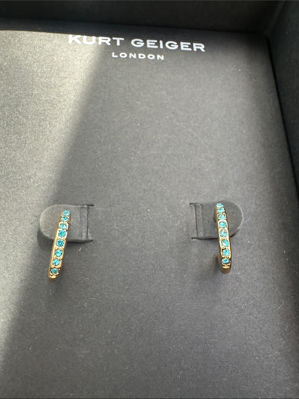 Kurt Geiger gold huggie earrings with blue crystals